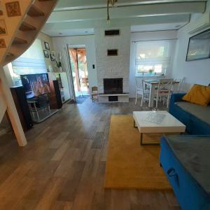 a living room with a blue couch and a table at Letnia Ostoja Wieprz in Wieprz