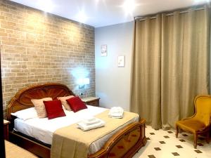 a bedroom with a bed and a brick wall at Casa vacanze in Soverato Marina