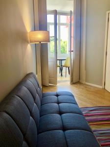 a living room with a blue couch and a table at Porto Republica Downtown in Porto