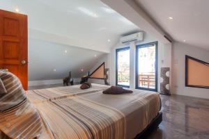 a large bed in a room with a large window at Malee Beach A1 in Ko Lanta +29 photos