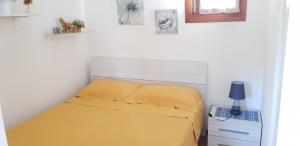 A bed or beds in a room at MARINA OF OLBIA APARTMENT