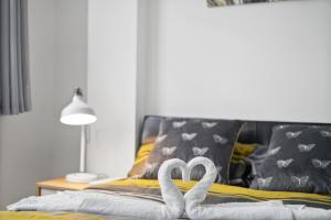 dos cisnes blancos sentados sobre una cama en STUDIO IN THE HEART OF THE CITY - ALDGATE ZONE 1 en Londres