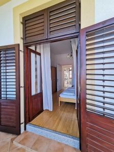 a room with a door and a bedroom with a bed at Apartments Balticadriatic in Dramalj