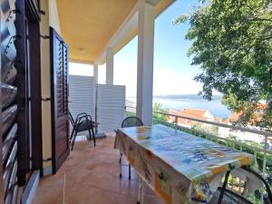 a balcony with a table and a view of the ocean at Apartments Balticadriatic in Dramalj +47 photos