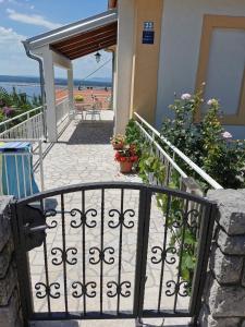 a staircase leading to a house with a gate at Apartments Balticadriatic in Dramalj