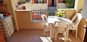 a white table and chairs on a balcony at MARINA OF OLBIA APARTMENT iun r3714 in Olbia