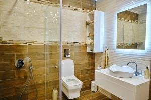 a bathroom with a toilet and a sink and a shower at Luxury Nevena Apartment - Bogoridi super centre in Burgas