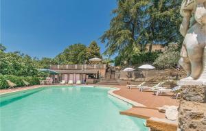 a large swimming pool with chairs and a building at Agriturismo Casale Le Burgne in Città di Castello