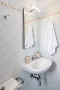 アギオス・イオアニスにあるPorto Vidaliのバスルーム(洗面台、鏡、トイレ付)