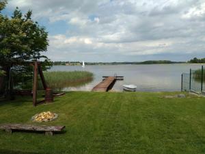 a dock on a body of water with a boat at Dar Kalu Małgosia in Kal