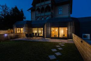 a house with a clock tower at night at Tamara Luxury Apartments in Bled