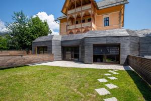 an exterior view of a house with a yard at Tamara Luxury Apartments in Bled