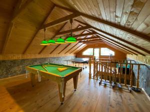 a room with a pool table in a house at Idylia Grand Villas in Migovo