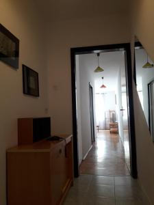 a room with a door open to a hallway with a box at ITA in Piran