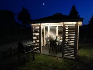 a gazebo with a table and a grill at night at MARKAS in Rewa