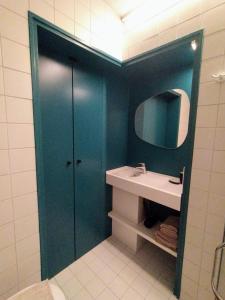 a bathroom with a sink and a mirror at HOTEL LEHOUCK in Koksijde