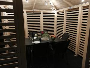 a table in a room with wooden shutters at MARKAS in Rewa