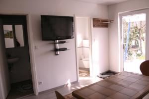a living room with a flat screen tv on the wall at Stumpf Verpachtung Gbr in Treuchtlingen