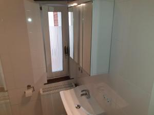 a bathroom with a sink and a mirror and a window at Ferienwohnung Loft ca. 45 qm in Anröchte +6 photos