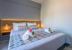 a bedroom with a bed with towels on it at Linda Apartments Platanias in Plataniás