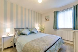 a bedroom with a bed and a window at Seaview - Cheviot Court in Broadstairs