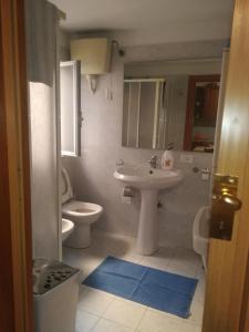 a bathroom with a sink and a toilet at Casa Marianna in Alcamo