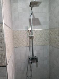 a shower with a shower head in a bathroom at Al-marsa2 in Al Hoceïma