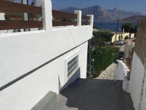 a stairway leading up to the side of a white building at Fotini Studios in Emborios