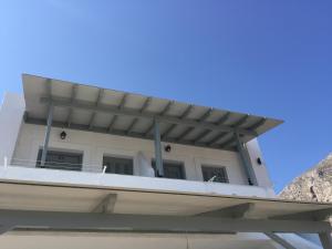 a house with a balcony on top of a boat at Fotini Studios in Emborios Kalymnos