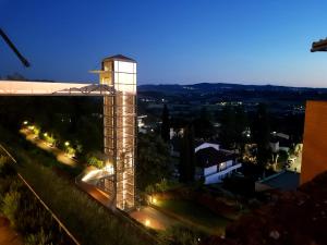 un edificio con una torre dell'orologio di notte di L' Atelier Tuscany a Peccioli
