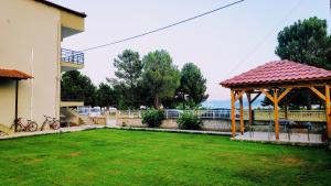 a garden with a gazebo in a yard at Ourania luxury apartment in Keramotí
