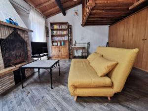 a living room with a couch and a table at Casa Con Soppalco ad Ariccia in Ariccia