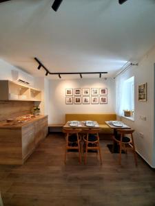 a kitchen with two tables and a counter at Casa Isabella B&B in Koper