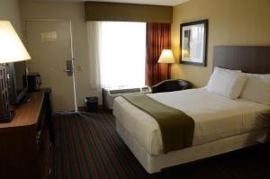 a hotel room with a bed and a television at Baymont by Wyndham Nashville Airport in Nashville