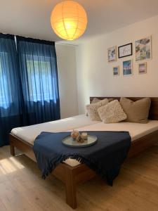 a bedroom with a bed with a tray of food on it at Amira Apartman in Komárno