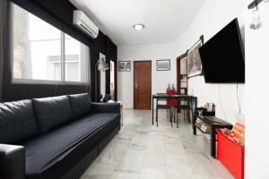 a living room with a couch and a television at MZ flat in Málaga