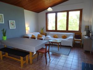 a living room with a white couch and a table at Masoveria de Cal Sastre in Girona