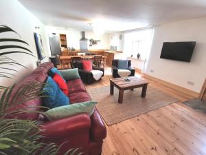 a living room with a couch and a table at THE OLD RECTORY GLEBE HOUSE in Jacobstow 10 mins to Widemouth bay and Crackington Haven,15 mins Bude,20 mins tintagel, 27 mins Port Issac in Bude