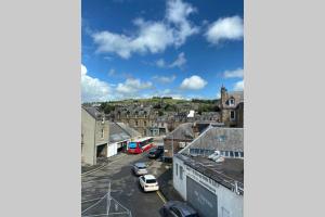 a view of a city with cars parked on a street at Town Centre Apartment in Hawick