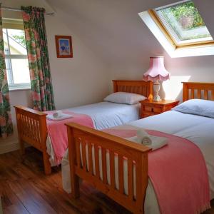 Кровать или кровати в номере Holiday Cottages Portsalon