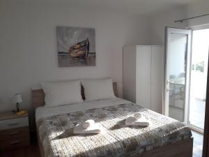 Postel nebo postele na pokoji v ubytování Apartments Gracia & Toni