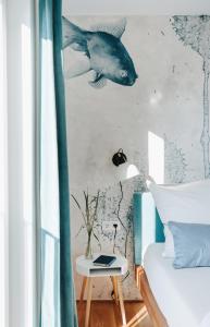 a bedroom with a mural of a fish on the wall at Rotes Haus Bregenz See Wohnung in Bregenz