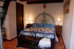 アスコリ・ピチェーノにあるB&B Terra Di Mezzoのベッドルーム(青いベッド1台、ドレッサー、ランプ付)