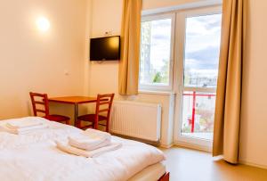 Postel nebo postele na pokoji v ubytování Sport Hotel České Budějovice