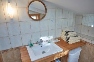 a bathroom with a sink and a mirror at Apartament ze słoneczną werandą -250 m do plaży in Sopot +5 photos