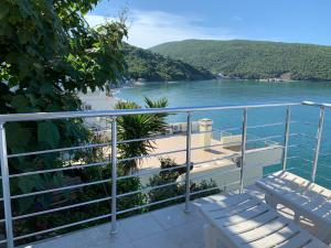 a balcony with chairs and a view of the water at Azzure Apartment in Ulcinj