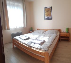 a bedroom with a bed with towels on it at Apartment Tánička - Chopok Juh, Tále in Brezno +38 photos