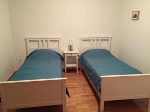 two beds sitting next to each other in a bedroom at Holiday Home Olea in Punat