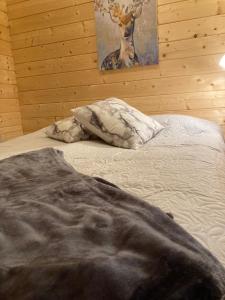1 dormitorio con 1 cama con una foto de ciervo en la pared en Asplunda Gård, Kolmården stuga nr 1, en Kolmården