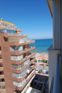 un edificio alto con el océano en el fondo en don juan, en Fuengirola